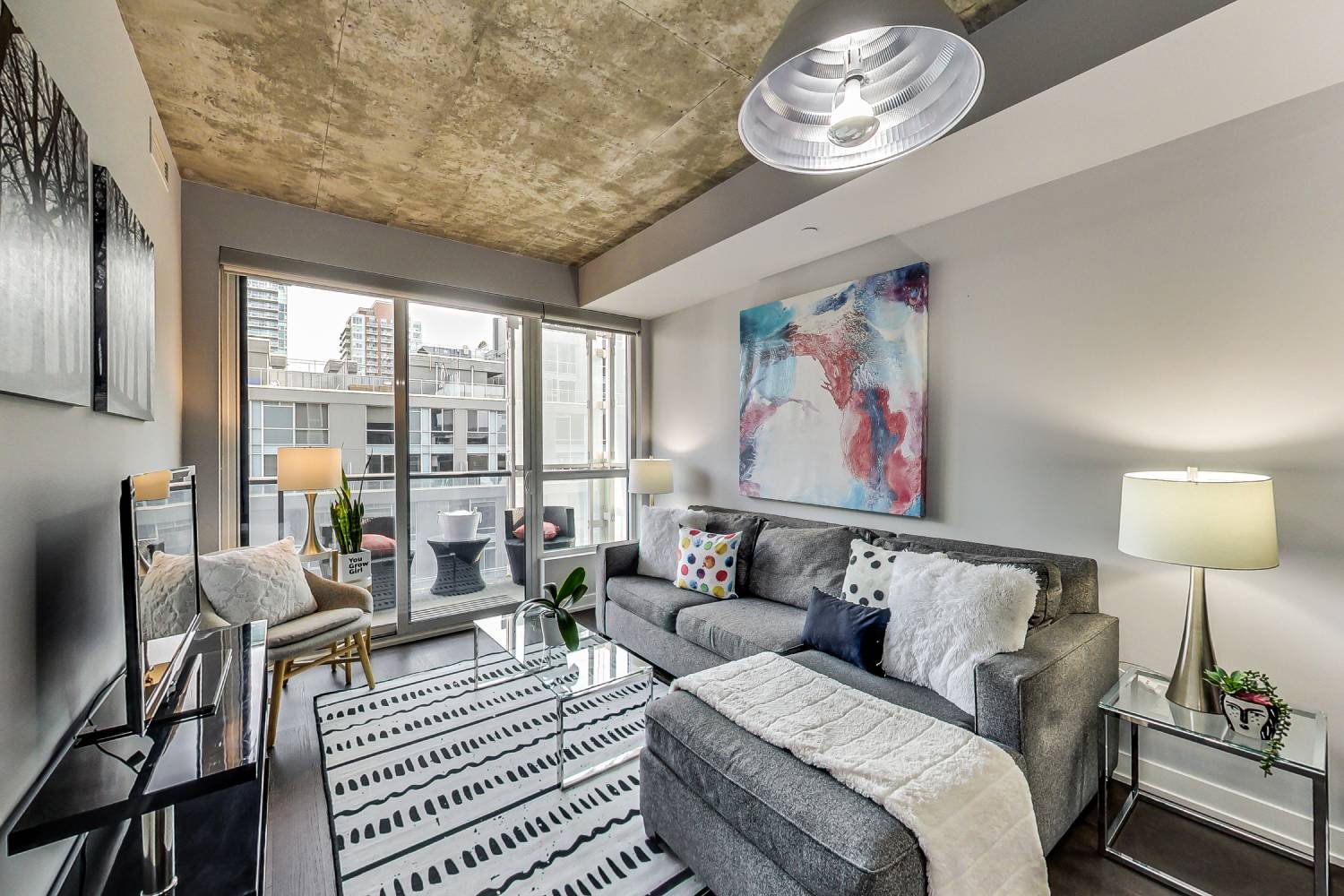 Floor-to-ceiling windows framing a downtown Toronto skyline in a home the team has sold